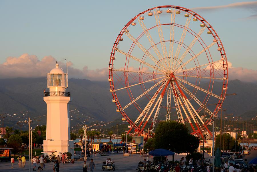 Panoramic Wheel and Lighthouse at Sunset