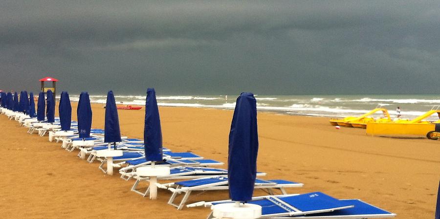 Sandy Beach with umbrellas and sunbeds